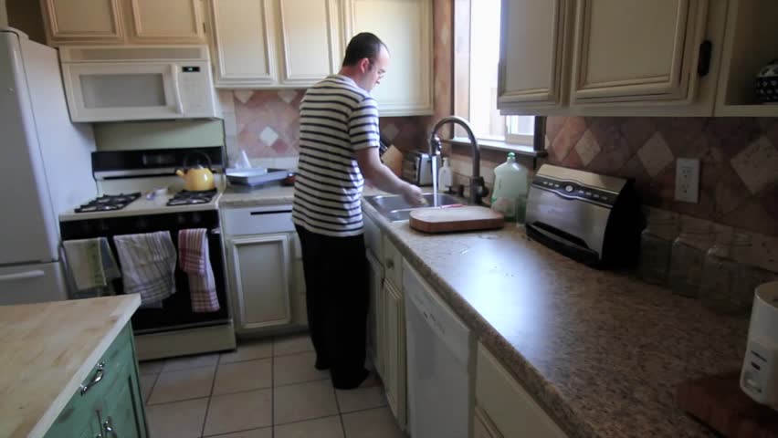 Man Cleans Kitchen