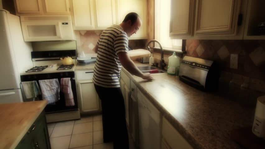 Man Cleans Kitchen