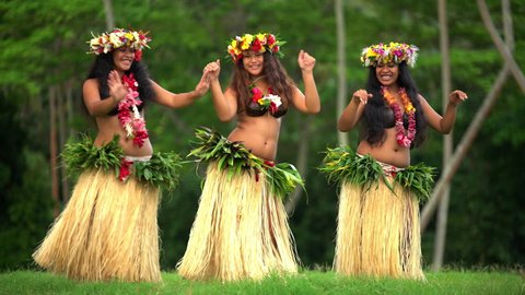 Young graceful female group of Tahitian hula dancers performing outdoor barefoot in traditional costume Tahiti French Polynesia South Pacific