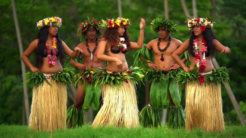 grass skirts and flower headdress dancing hula style while entertaining bar...