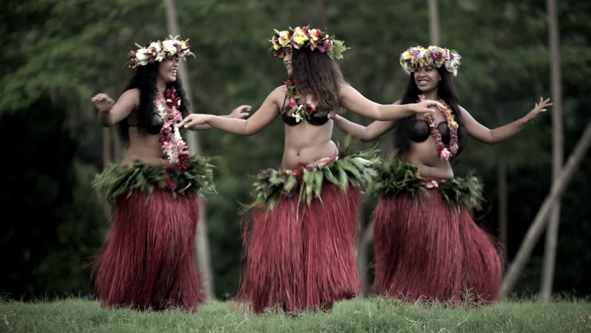 Young graceful female group of Tahitian hula dancers performing outdoor bar...