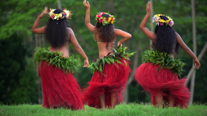 skirts and flower headdress dancing hula style while entertaining barefoot ...