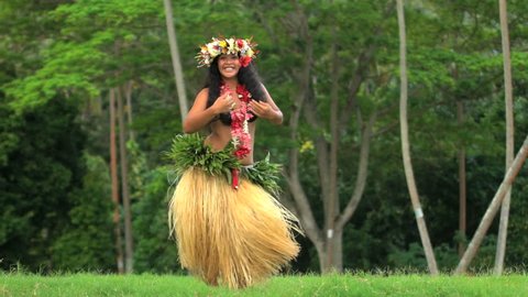 Young Polynesian Tahitian female hula dancer performing outdoor barefoot in traditional costume Tahiti French Polynesia South Pacific