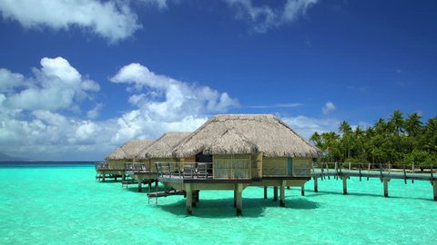 Overwater luxury Bungalows in tropical Aquamarine lagoon a Tahitian hotel resort of Bora Bora Island in the South Pacific French Polynesia