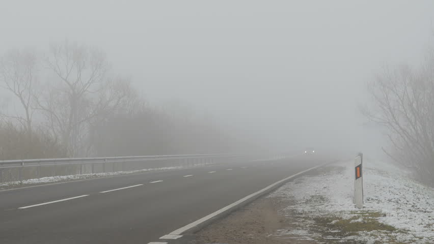 Fog on the road, poor driving conditions. Cars ride on the road and shining lights in the fog. Winter. | Shutterstock HD Video #22494724