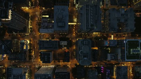 Aerial vertical overhead rooftop illuminated view of Chicago city streets road traffic and Downtown Skyscraper buildings Business and Financial District USA Illinois RED DRAGON Arkistovideo