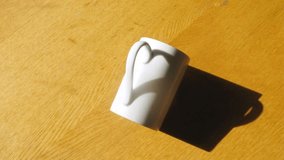 Cup stands on yellow table under an slope and sunlight, time lapse - Powered by Shutterstock - Get 15% off with code: PIKWIZARD15