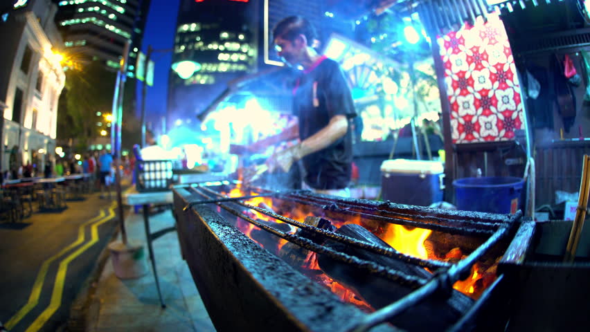 Singapore - September 2016: Male cooking traditional Asian chicken kebab street food outdoor on a coal barbecue fire at night in Asian Food Market South East Asia | Shutterstock HD Video #22497412