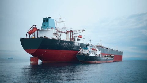 Cargo ship refueling at sea