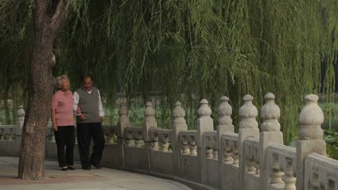 WS Elderly couple walking through park together / China