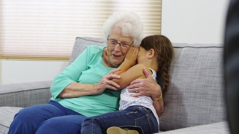Smiling grandma hugging granddaughter