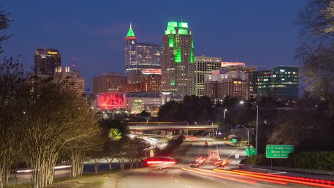 Raleigh NC Cityscape Night Timelapse with Moving Traffic Entering Downtown as the Sun Sets into the Night Showcasing the Lit Building Landscape of the North Carolina Capital City