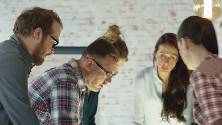 Seven Stylish Diverse People Lean on a Conference Table While Energetically Discussing Daily Business Plans. Shot on RED EPIC 4K(uhd). Royalty-Free Stock Footage #22522198