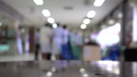 Blurred image of unidentified people and patient in hospital waiting medicine or doctor