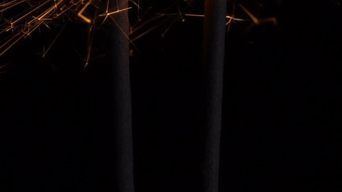 Burning sparklers in the dark. New Year's fireworks in the dark. Slow-motion filming
