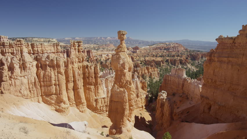 Wide panning shot of rock formations in canyon / Bryce Canyon National Park, Utah, United States