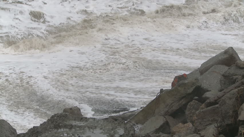 Storm driven waves destroy a coastal road