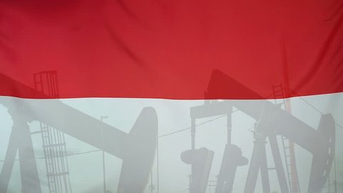Concept oil production in Indonesia oil pumps and indonesian flag in slow motion movement