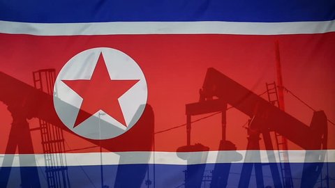 Concept oil production in North Korea oil pumps and north korean flag in slow motion movement