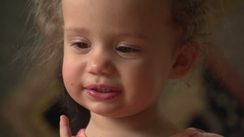Cute little girl eating a cookie, close up