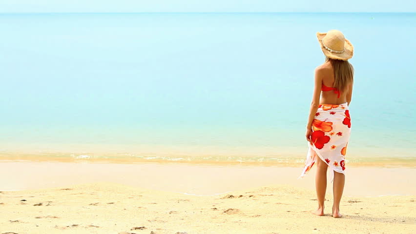 Sweetie wearing pareo and bikini posing at tropical beach
