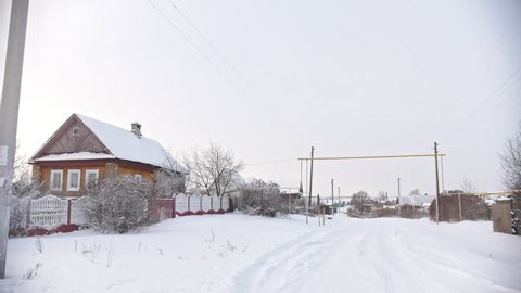 Winter road at typical Russian countryside - village in center of Volga, snow cold day