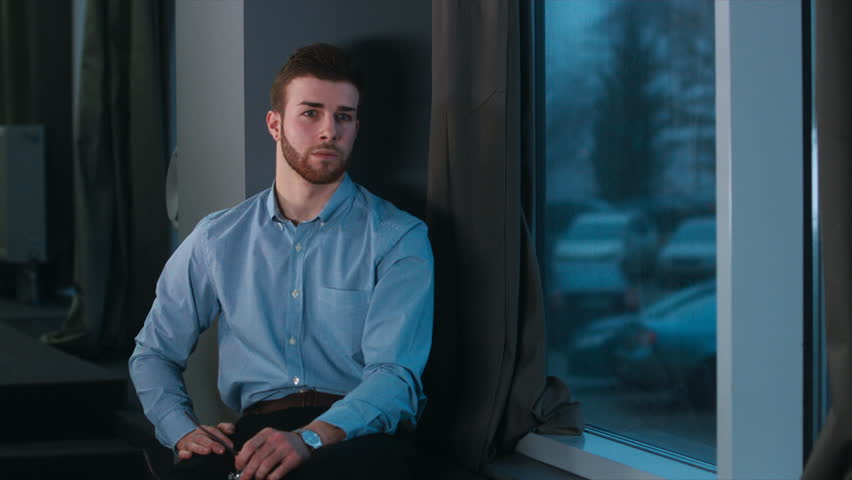 Portrait of young successful Businessman entrepreneur working at trendy start up office. Casual clothes. Caucasian male looking into camera. 4K UHD 60 FPS slow motion