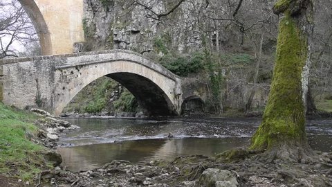 A river that passes under two old bridges