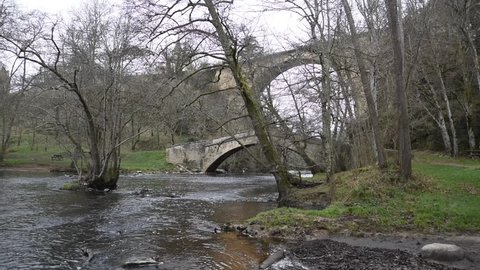 A river that passes under two old bridges