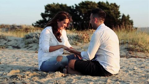 Happy young couple in love on the beach, toned video