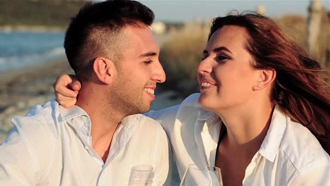 Happy young couple in love on the beach, toned video