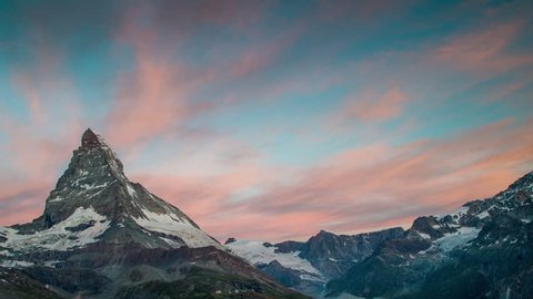 dawn, sunrise time lapse of the amazing matterhorn mountain in the Swiss Alps. the sky lights up in an incredible display of colour followed by the shadow lowering over the mountain