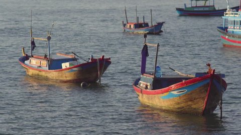 Vietnamese fishing boats in a sea at sunrise. Nha Trang, Vietnam travel landscape and destinations.