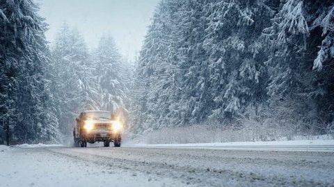 Cars Drive Through Forest In Snowstorm - Tracking Slowly Sideways