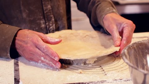 Woman pressing pie dough close up on hands- slider shot.mov