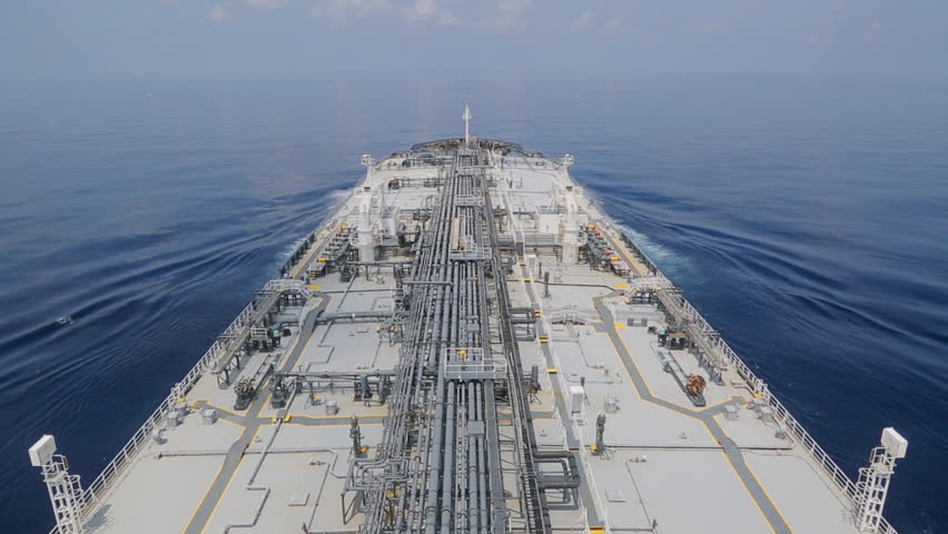 Grey oil tanker is underway at sea.