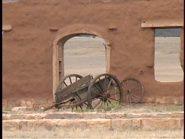 Smooth zoom out from an old wagon on the grounds of Fort Union National Monument