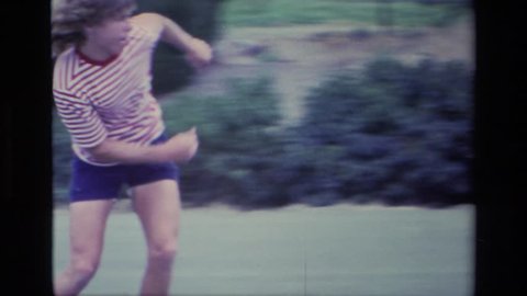 ALISO VIEJO CALIFORNIA 1976: an older boy rides a skateboard up a homemade ramp