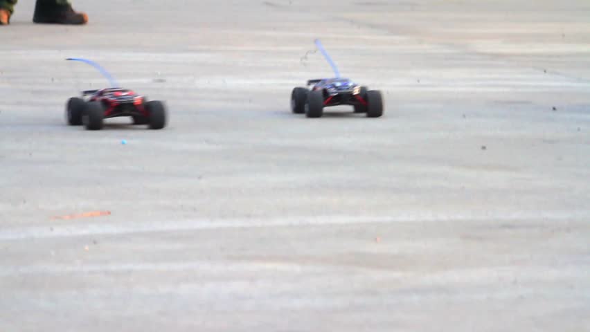 Electric RC cars drive by the camera 
