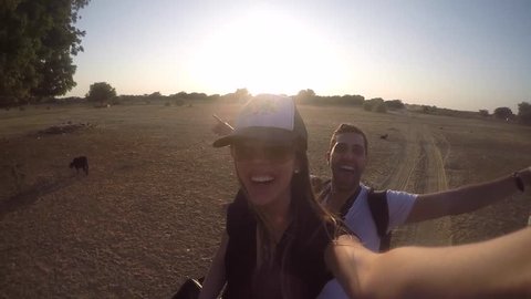 Couple taking a selfie in a camel riding in desert