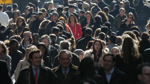 NEW YORK - CIRCA February 2012: Commuter Businessmen and women walk down street sidewalk in midtown Manhattan