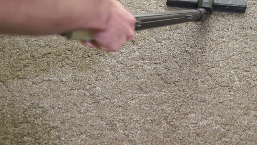 Vacuuming a carpet.