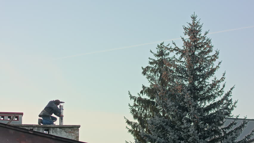 Builder man worker screwing self tapping screw with screwdriver machine during roofing construction works