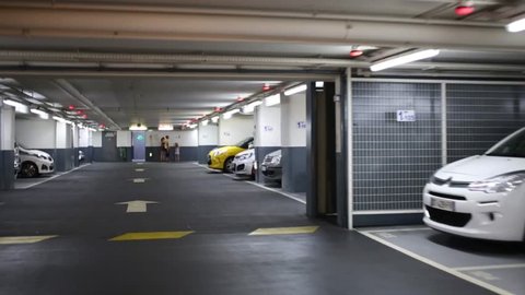 NICE, FRANCE - JULY 26, 2016: Movement on underground parking with many cars on parking lots