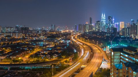 Kuala Lumpur Central Business District skyline sunrise night to day time lapse. tilt up