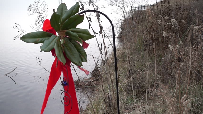 Christmas ribbon on the edge of a lake. Like a lake house concept