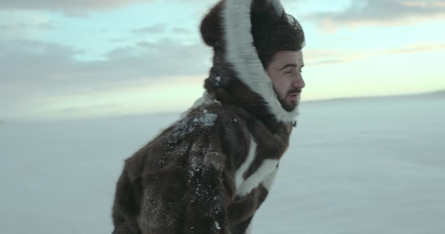 A portrait of tired traveler who going away along winter field  at snow blizzard. Yamal 2016. Shot on Red Epic 4k. 