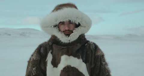 Portrait of young man dressed in reindeer coat. Man looking seriously in camera. Shot on Red Epic