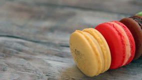 Colorful sweet macaroons on rustic wooden background