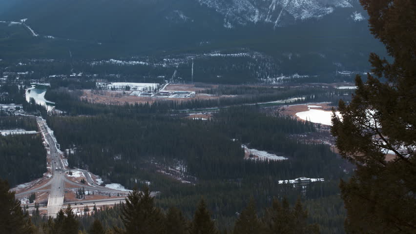 High altitude pan of the town of Banff, Alberta and surrounding area.